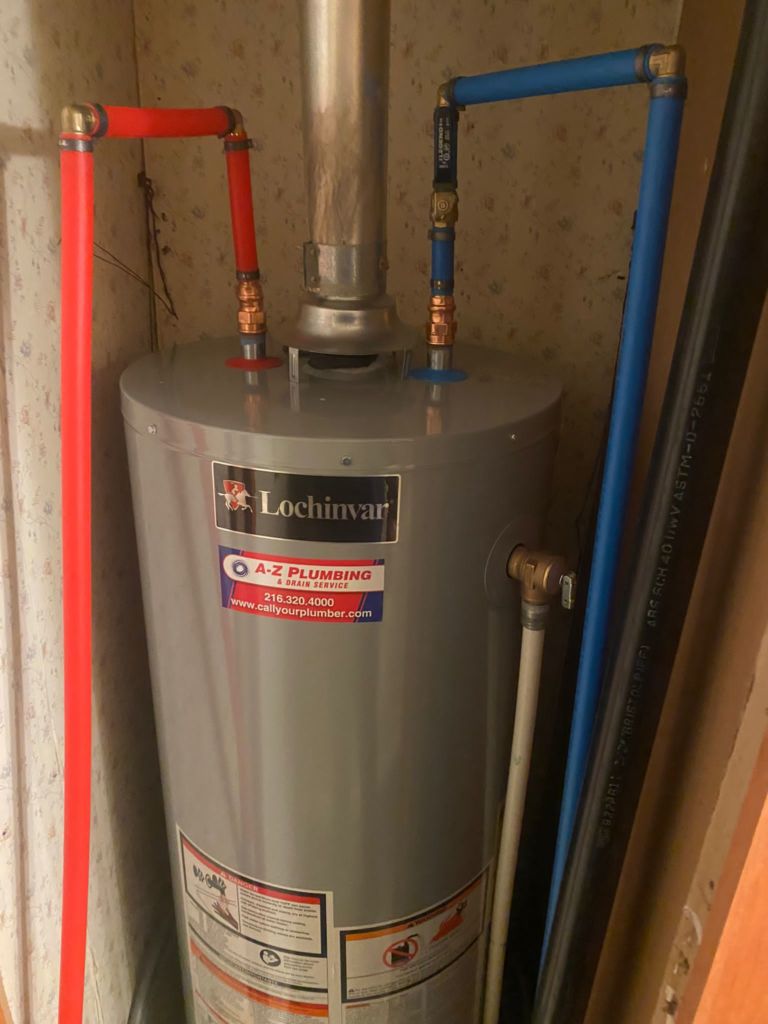 d236c38c-62b0-4630-a9d0-ea91a8036f91 Lochinvar residential water heater installed with red and blue PEX supply lines, labeled by A-Z Plumbing & Drain Service for hot water installation or repair service.
