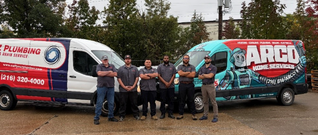 A-Z Plumbing and Arco Home Services team standing between their service vans